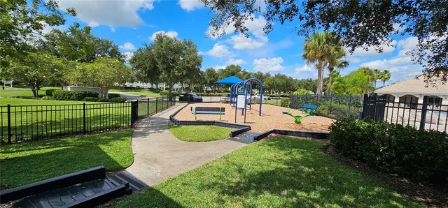 a view of a park with furniture and a yard