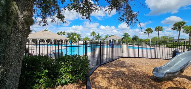 a view of a balcony with furniture and red umbrella