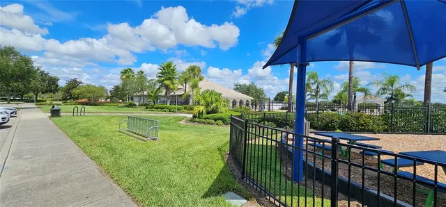 a front view of a house with a yard and fountain