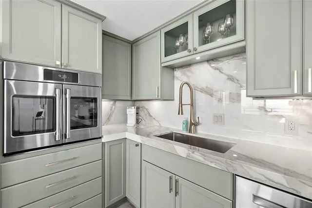 a kitchen with stainless steel appliances granite countertop a sink and a microwave