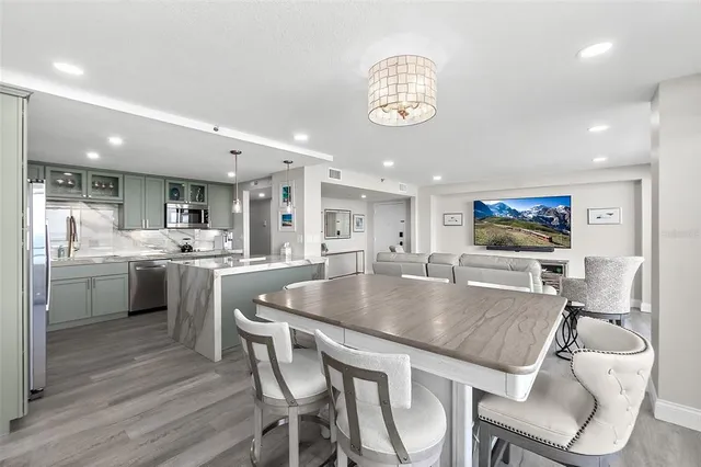 a large kitchen with a table and chairs