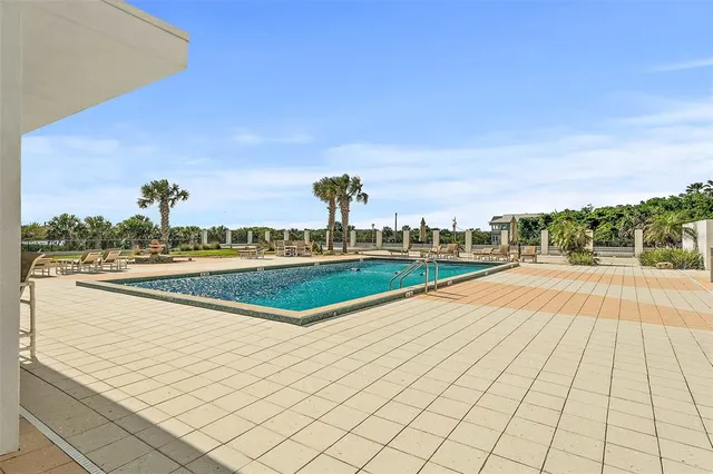 a view of swimming pool with outdoor seating and yard