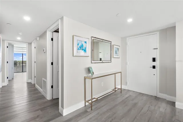a view of a hallway with wooden floor and staircase