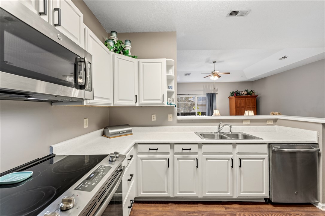 160 Wexford Drive, Unit 206 Anderson, SC 29621 - Photo 5 of 31 Prepare meals in a kitchen featuring sleek appliances and open views to the living space.