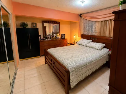 a bedroom with a bed and large mirror