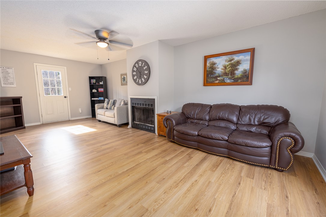 410 South Cove Road Seneca, SC 29672 - Photo 13 of 25 This inviting living space features warm flooring and a cozy fireplace, perfect for relaxation and gatherings.