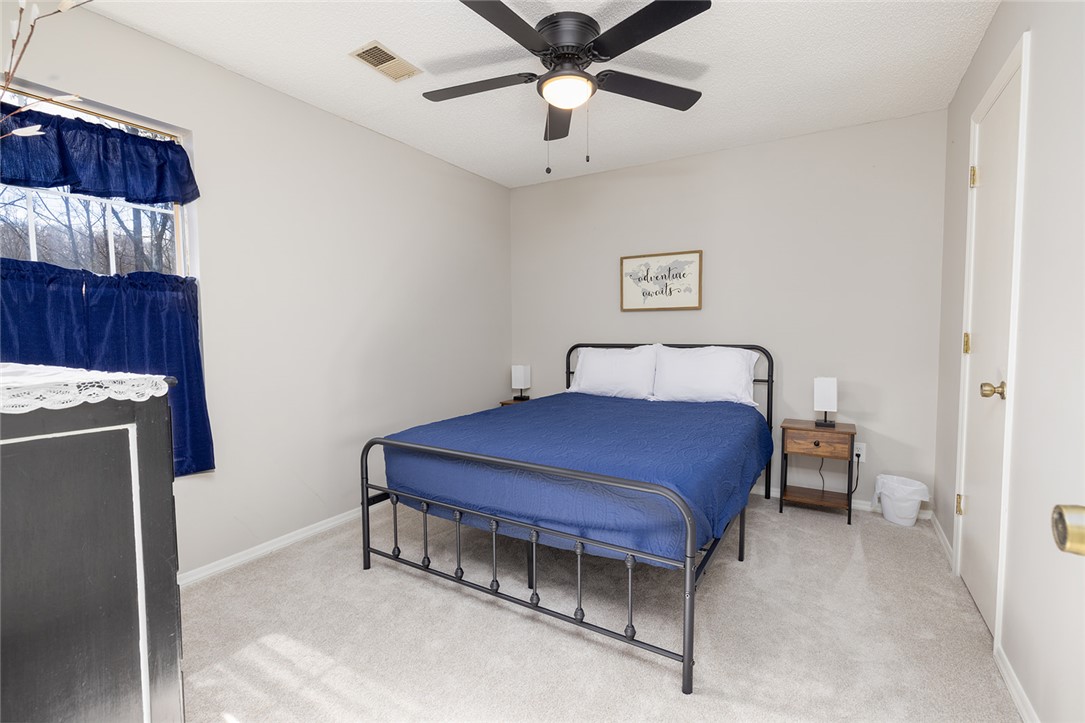 410 South Cove Road Seneca, SC 29672 - Photo 19 of 25 This cozy bedroom features a neutral color palette and abundant natural light.