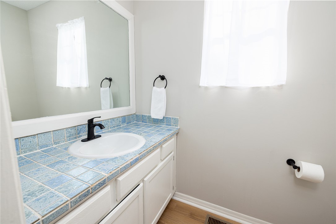 410 South Cove Road Seneca, SC 29672 - Photo 22 of 25 This clean and inviting bathroom features a tiled vanity and a well-lit space.