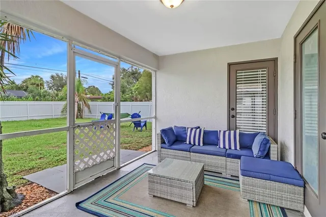 a living room with furniture and a floor to ceiling window