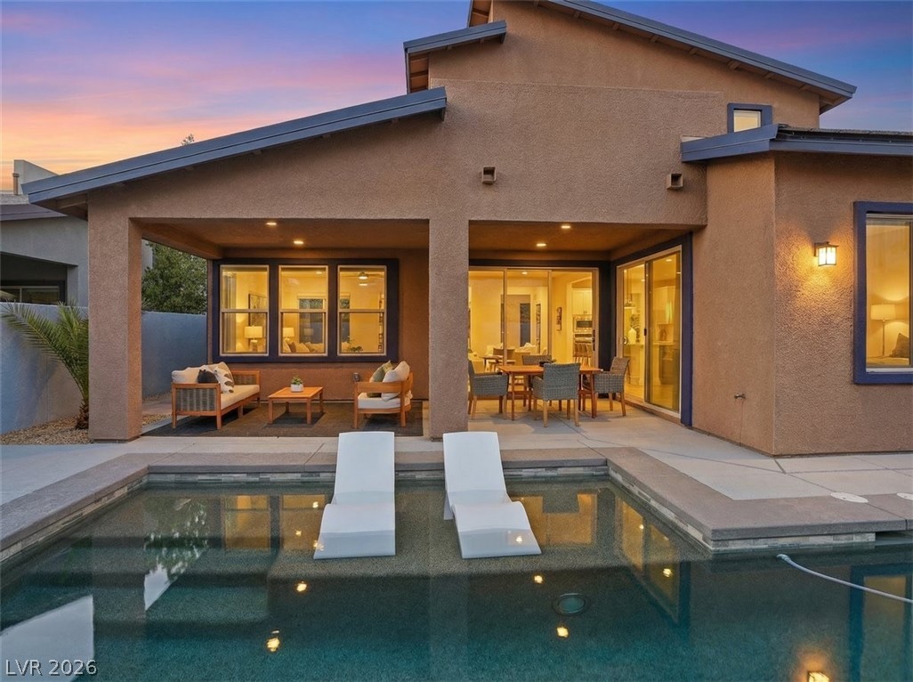 9725 Starlight Ridge Avenue Las Vegas, NV 89148 - Photo 43 of 47 This contemporary home features an inviting outdoor area with a covered patio and a refreshing pool.