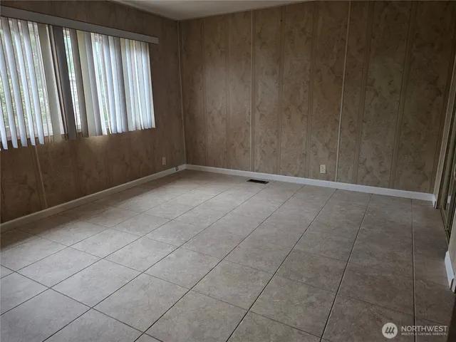 a view of a livingroom with furniture and an empty room