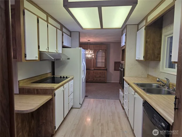 a view of livingroom with kitchen view and furniture