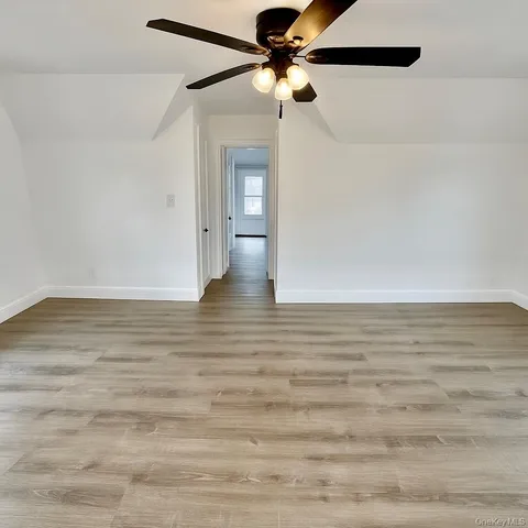 a view of a room with wooden floor