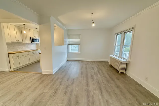 a view of a kitchen with wooden floor and a sink