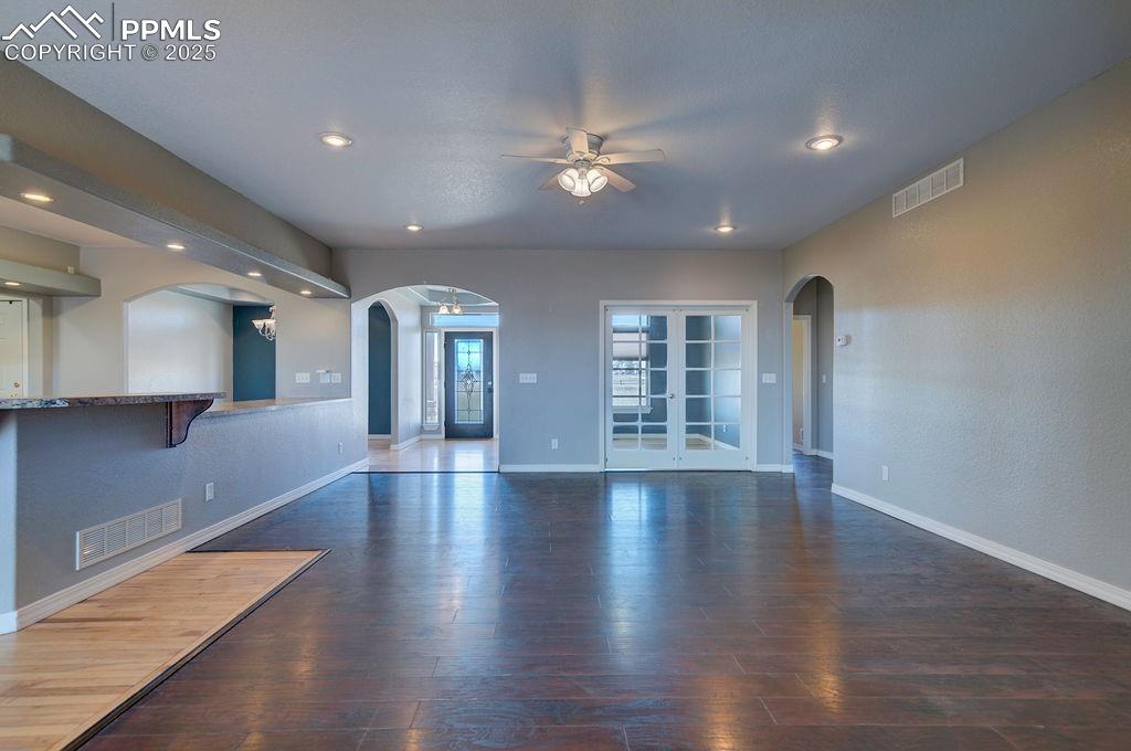 10935 McKissick Road Peyton, CO 80831 - Photo 15 of 50 an empty room with wooden floor and windows