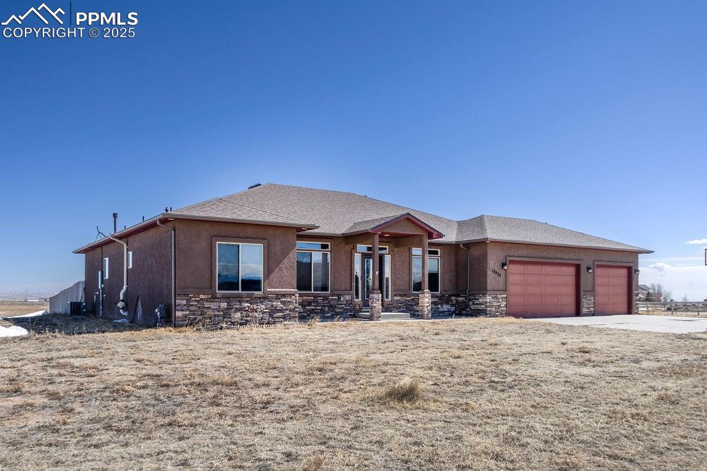 10935 McKissick Road Peyton, CO 80831 - Photo 2 of 50 a front view of a house with a yard