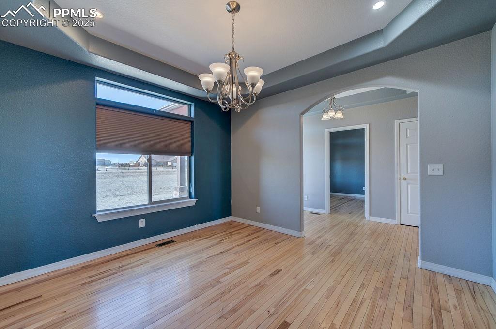 10935 McKissick Road Peyton, CO 80831 - Photo 23 of 50 a view of an empty room with wooden floor and a window