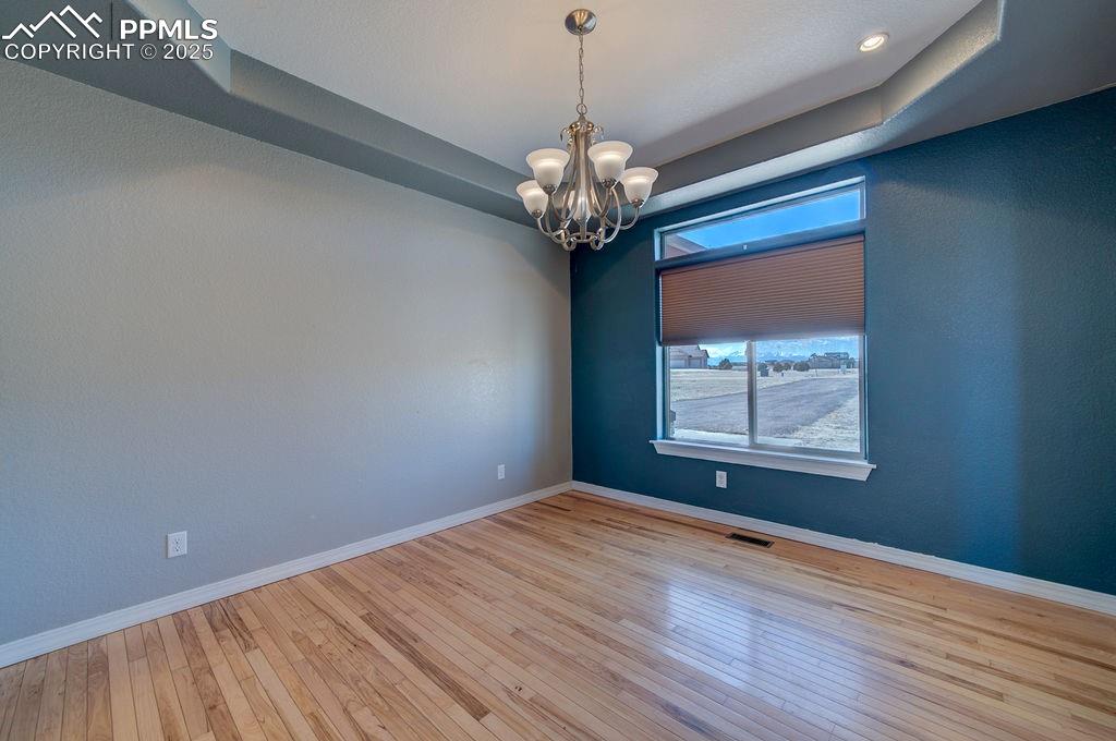 10935 McKissick Road Peyton, CO 80831 - Photo 24 of 50 a view of a room with window wooden floor and chandelier