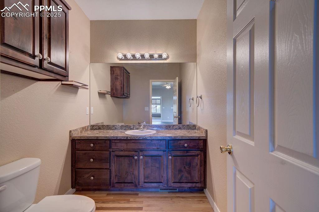 10935 McKissick Road Peyton, CO 80831 - Photo 28 of 50 a bathroom with a granite countertop sink and a mirror