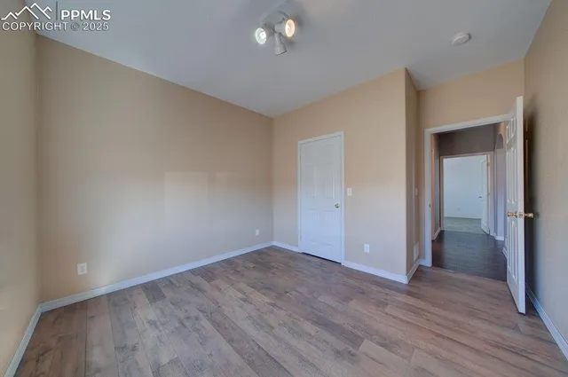 a big room with closet and wooden floor