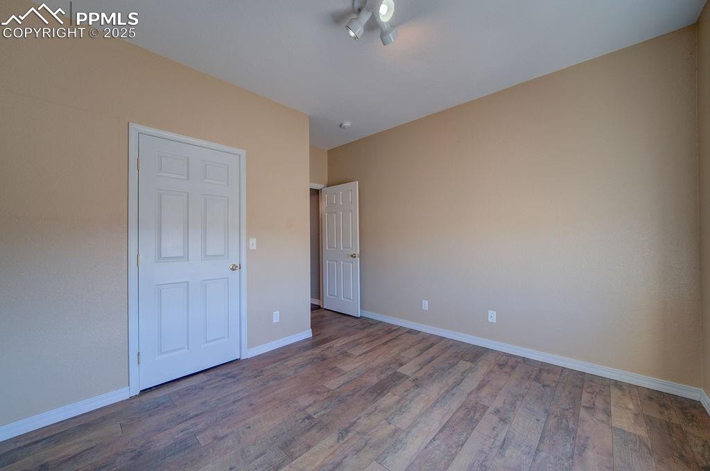 10935 McKissick Road Peyton, CO 80831 - Photo 31 of 50 a view of an empty room with wooden floor