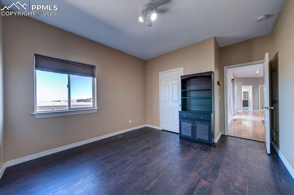 10935 McKissick Road Peyton, CO 80831 - Photo 34 of 50 a big room with closet and wooden floor
