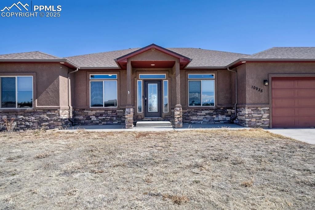 10935 McKissick Road Peyton, CO 80831 - Photo 4 of 50 a front view of a house with lots of trees