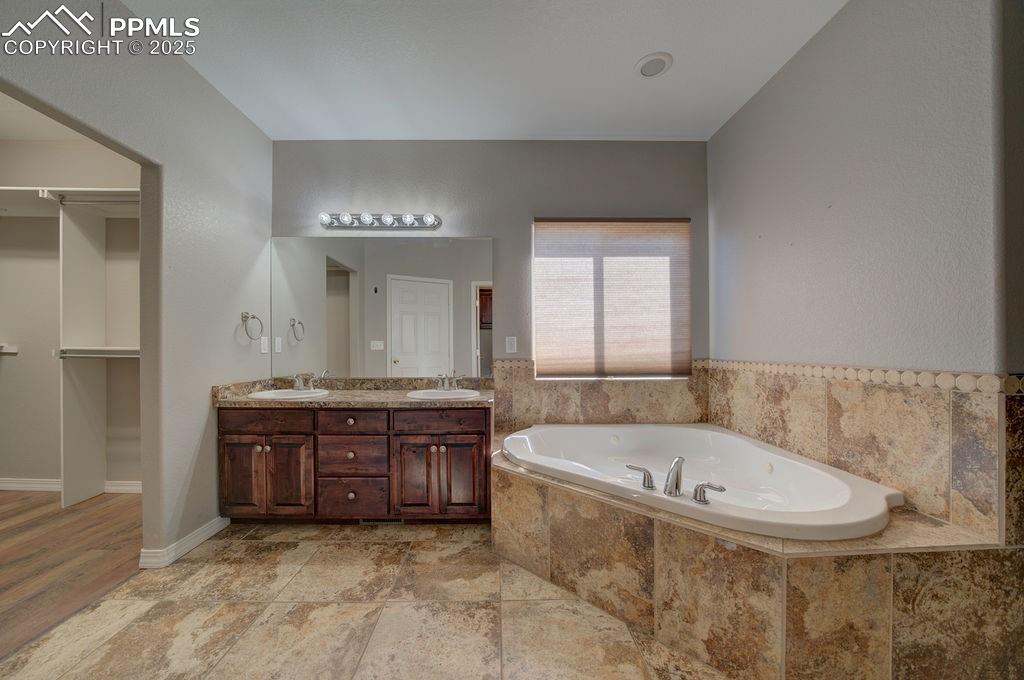 10935 McKissick Road Peyton, CO 80831 - Photo 43 of 50 a spacious bathroom with a tub sink and mirror