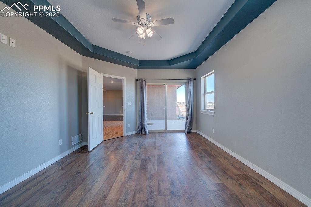 10935 McKissick Road Peyton, CO 80831 - Photo 45 of 50 a view of an empty room with window and wooden floor