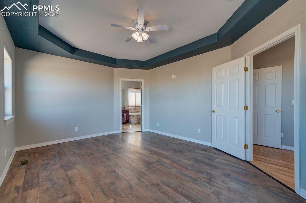 10935 McKissick Road Peyton, CO 80831 - Photo 47 of 50 a view of an empty room with window and wooden floor