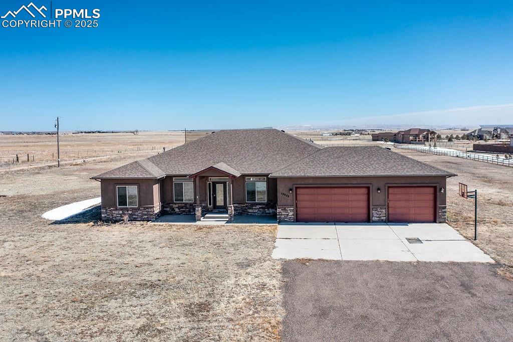 10935 McKissick Road Peyton, CO 80831 - Photo 7 of 50 a front view of a house with a yard