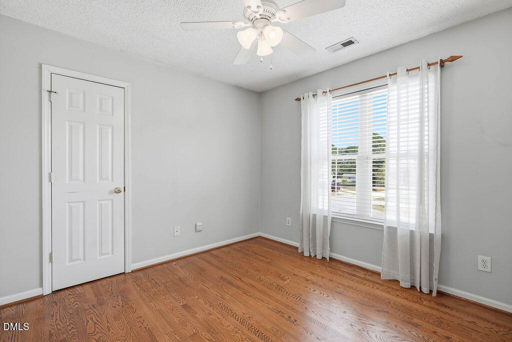 1560 Cane Mill Road Coats, NC 27521 - Photo 29 of 32 a view of an empty room with wooden floor and a window