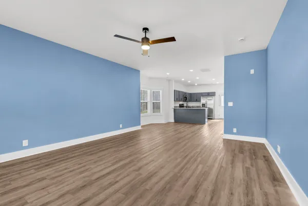 a view of kitchen with wooden floor and electronic appliances