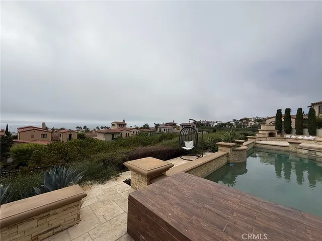 a view of a lake with couches chairs