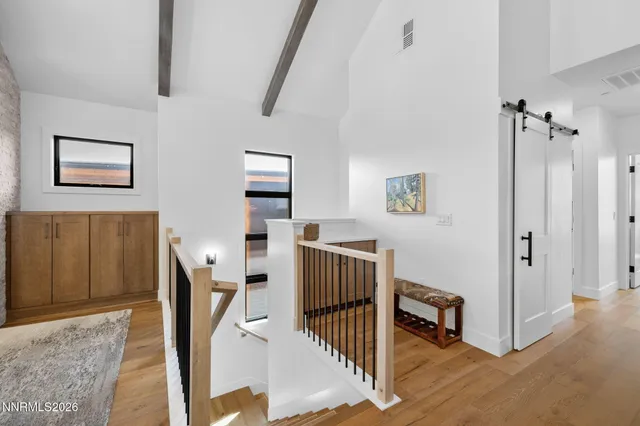 a view of a hallway with workspace and a window