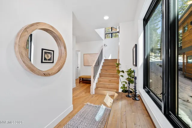 a view of a hallway with wooden floor and entryway