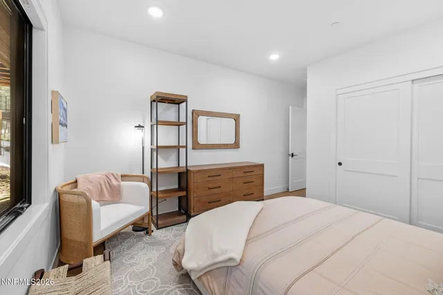 a bathroom with a granite countertop sink toilet and mirror