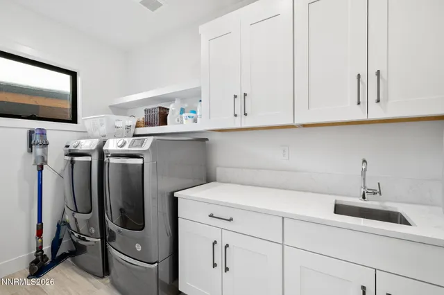 a bedroom with a bed dresser flowerpot and a window