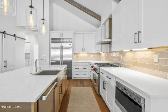 a kitchen with a sink stove and refrigerator