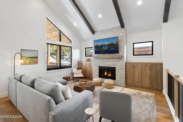 a living room with furniture a flat screen tv and a fireplace