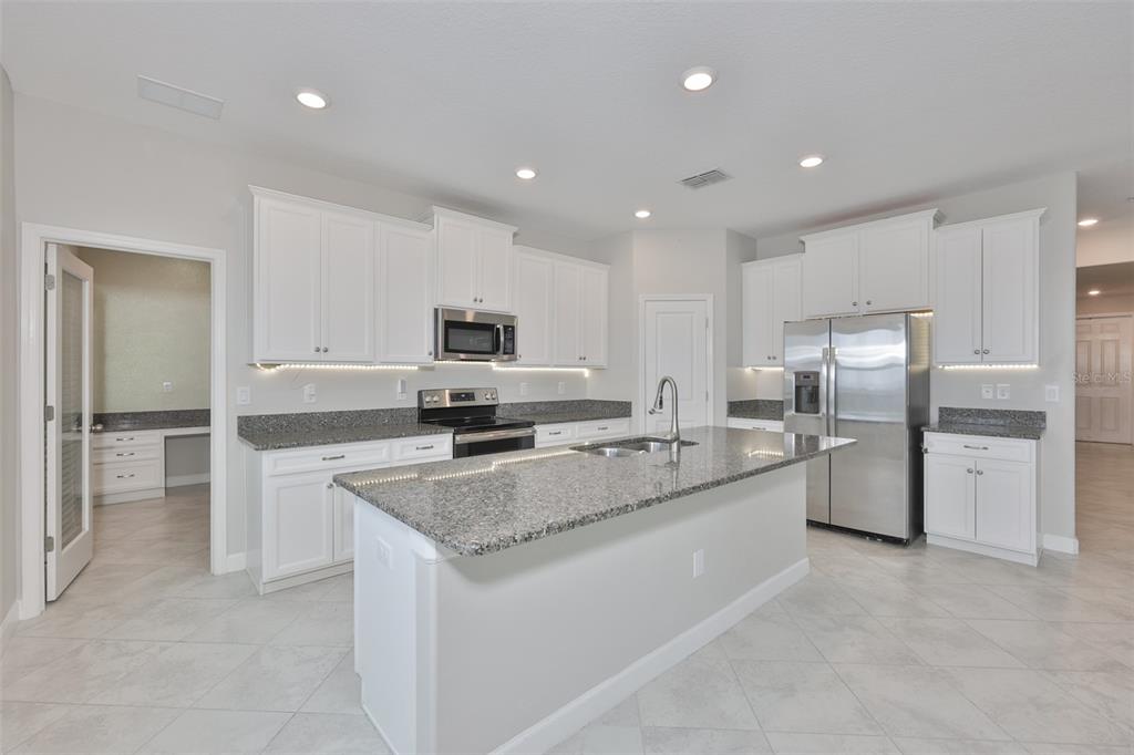 11454 Freshwater Ridge Drive Riverview, FL 33569 - Photo 13 of 65 a large kitchen with cabinets