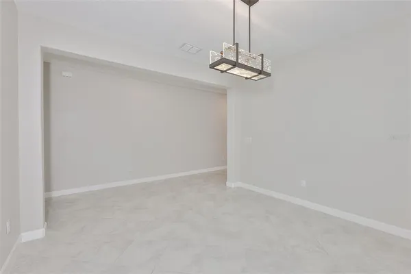 an empty room with a empty space and windows