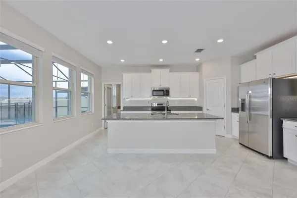a view of an empty room with a ceiling fan