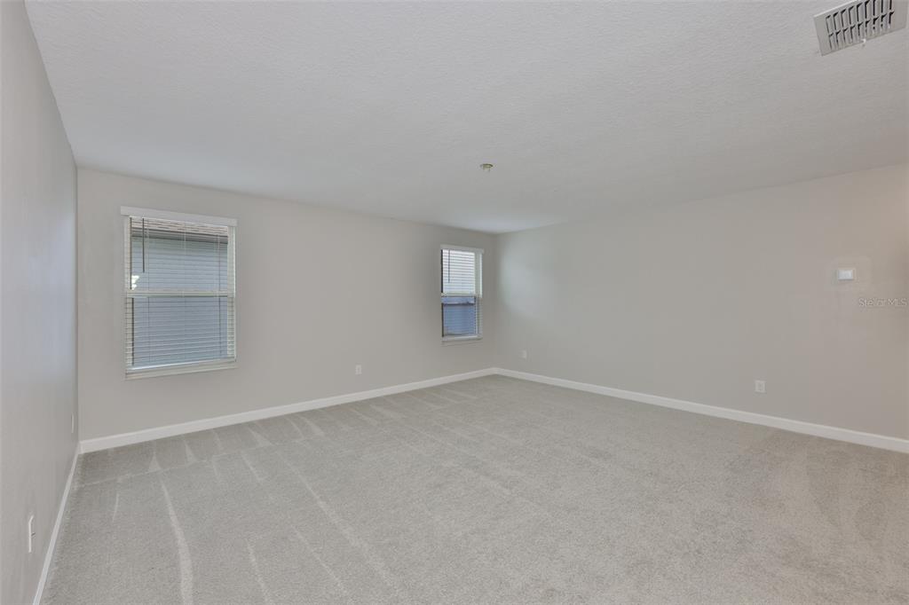 11454 Freshwater Ridge Drive Riverview, FL 33569 - Photo 29 of 65 an empty room with a empty space and windows