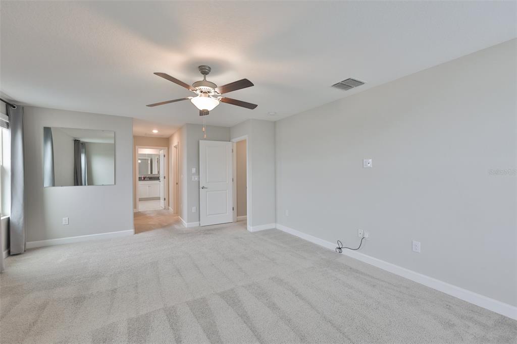 11454 Freshwater Ridge Drive Riverview, FL 33569 - Photo 30 of 65 a view of an empty room with a ceiling fan