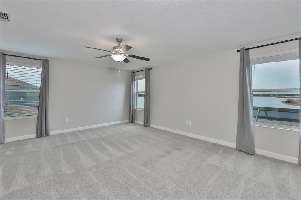 11454 Freshwater Ridge Drive Riverview, FL 33569 - Photo 32 of 65 a view of an empty room with a ceiling fan