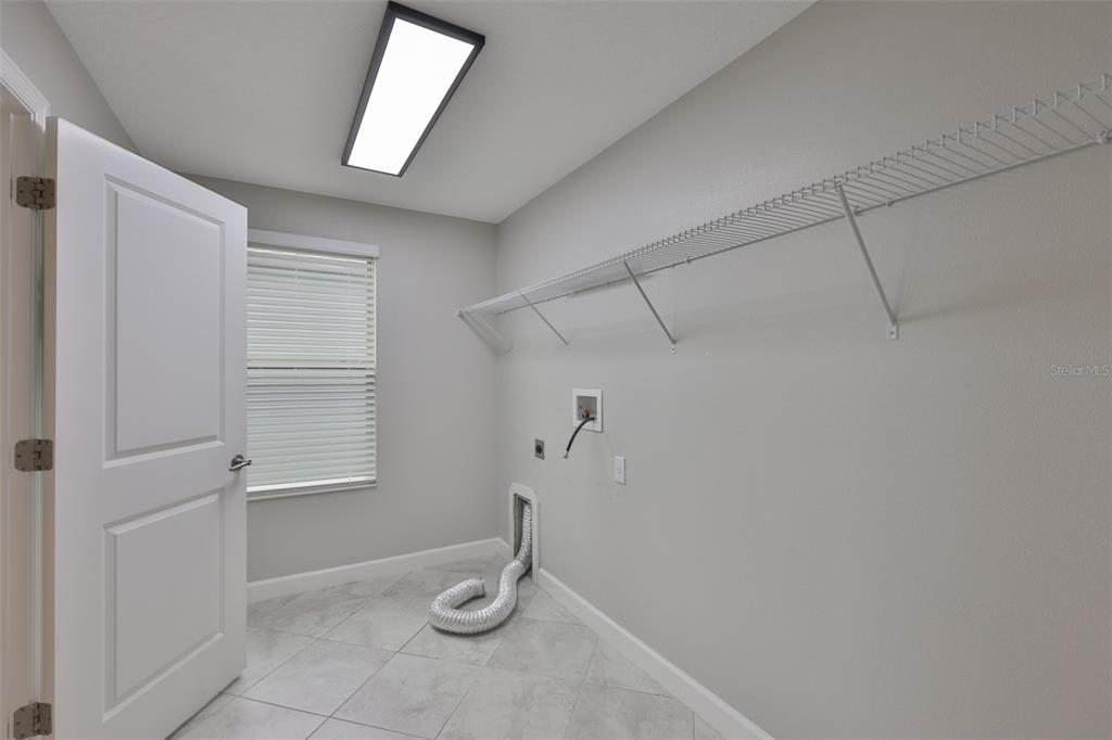 11454 Freshwater Ridge Drive Riverview, FL 33569 - Photo 33 of 65 a view of a storage & utility room with a window