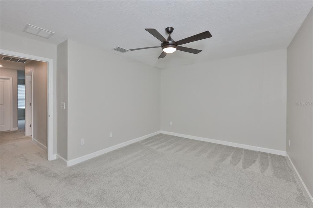11454 Freshwater Ridge Drive Riverview, FL 33569 - Photo 39 of 65 a view of a room with a fan