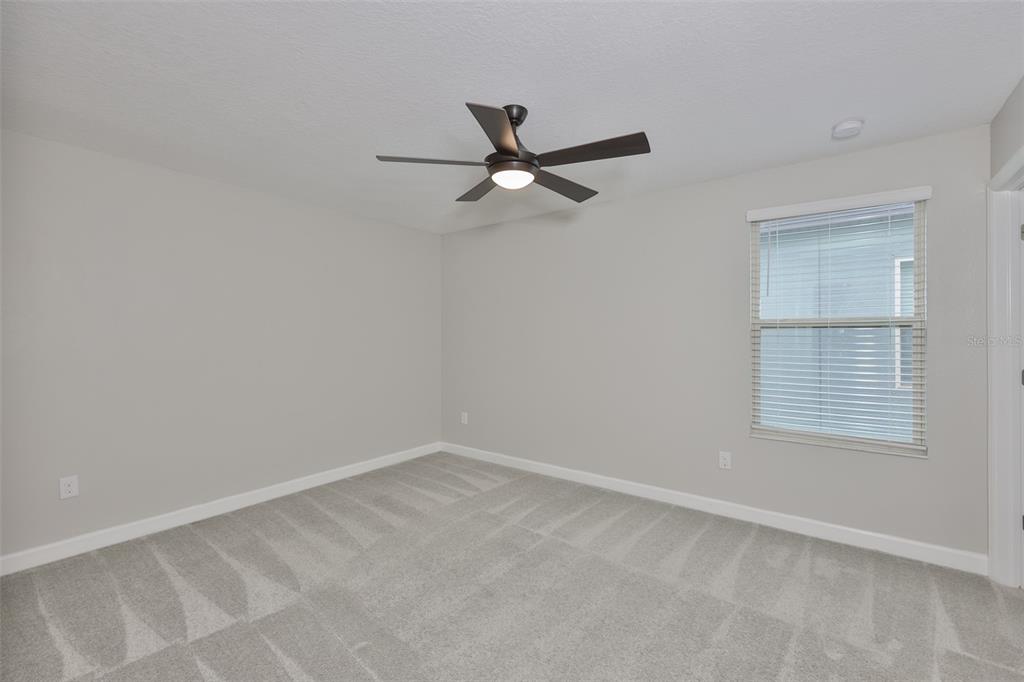 11454 Freshwater Ridge Drive Riverview, FL 33569 - Photo 40 of 65 an empty room with a window and a fan
