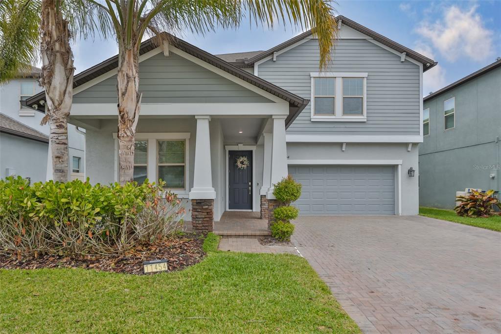 11454 Freshwater Ridge Drive Riverview, FL 33569 - Photo 4 of 65 a front view of a house with a garden and plants